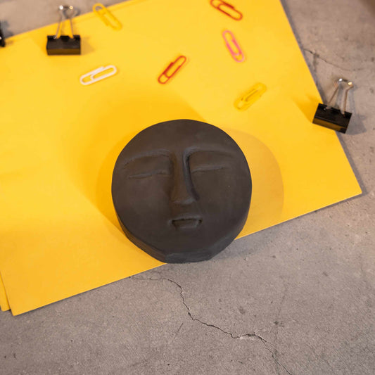 Phiz- Dark Concrete Round Face shaped Paper Weight for a work desk, office, and study table.